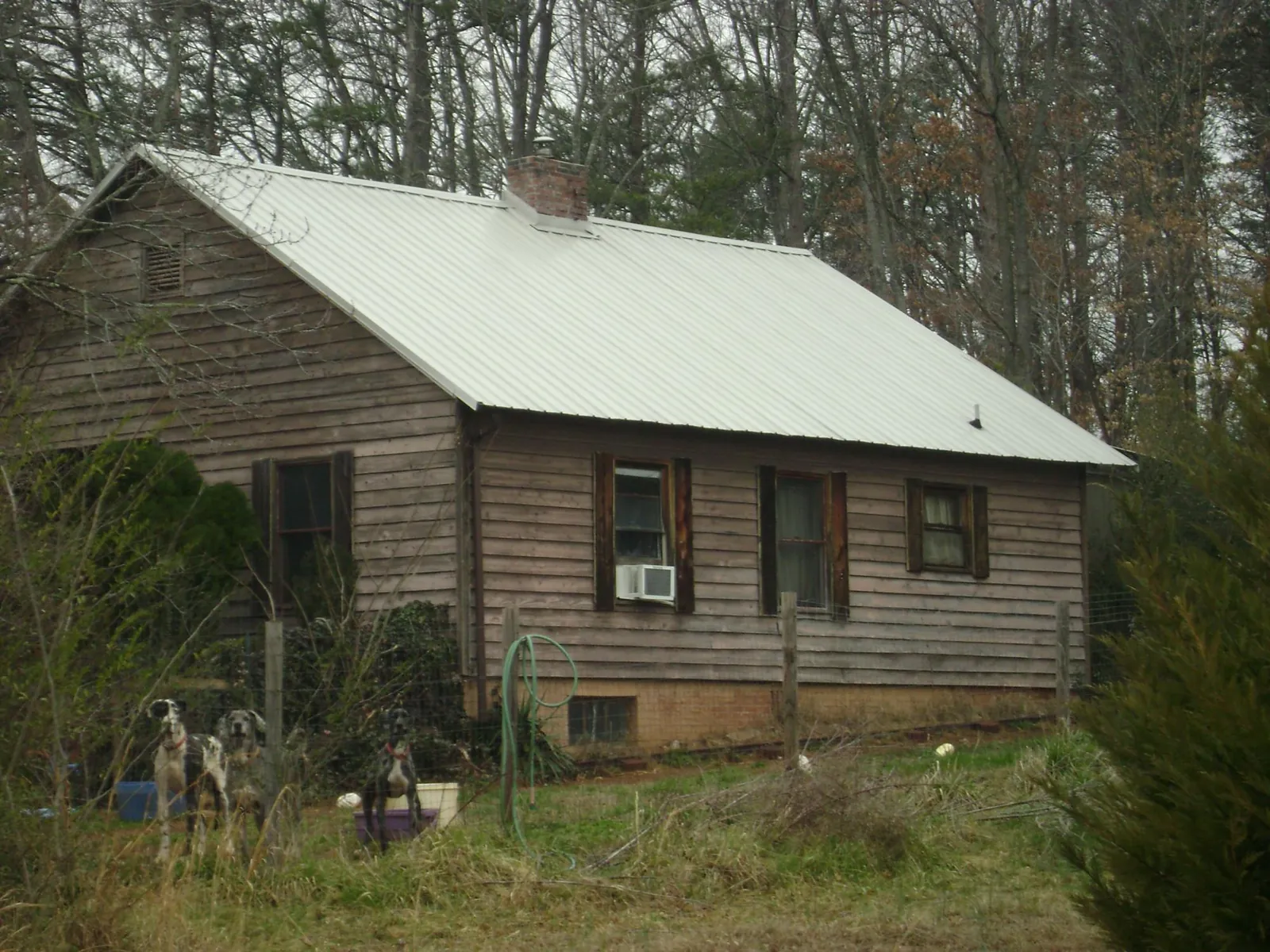 White metal roof on an old wood sided farmhouse, from a Metal Roof Installation job in Battleboro